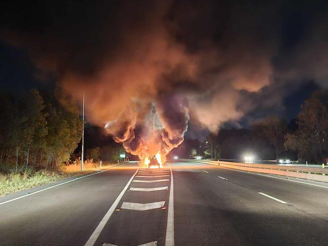 Highway gridlock as car erupts in flames, fire spreads