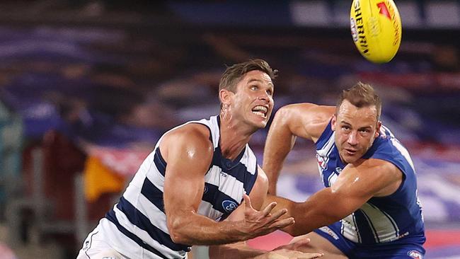 Geelong’s Tom Hawkins pushes away from Josh Walker for a mark at the Gabba. Picture: Michael Klein