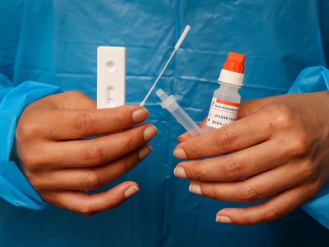 Registered Nurse On Hongsopha  of Suretest in Melbourne with a Rapid Antigen Test kit. Picture: Ian Currie