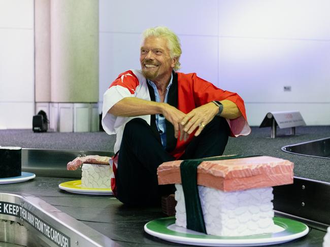 Sir Richard Branson joins a giant sushi train at Brisbane Airport to promote Virgin Australia's new route from Brisbane to Haneda, Tokyo. Pic: Jen Dainer