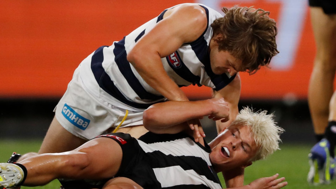 MELBOURNE, AUSTRALIA - APRIL 02: Tom Atkins of the Cats wrestles with Jack Ginnivan of the Magpies during the 2022 AFL Round 03 match between the Collingwood Magpies and the Geelong Cats at the Melbourne Cricket Ground on April 02, 2022 In Melbourne, Australia. (Photo by Dylan Burns/AFL Photos via Getty Images)