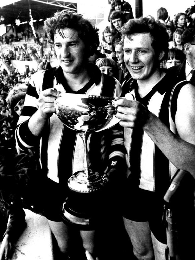 Glenorchy playing-coach Peter Hudson holding the 1975 premiership cup with Glenorchy captain Darryl Sutton.