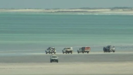 Authorities line the shore of Cable Beach after Charles Cernobori was killed in a shark attack. Picture: ABC News