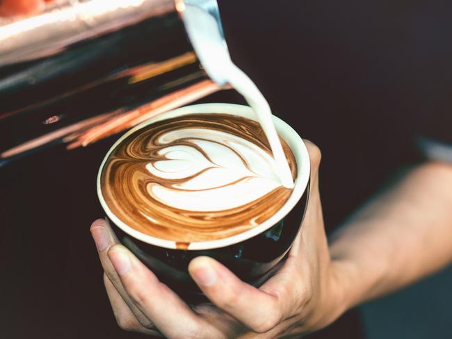 How to make latte art by barista focus in milk and coffee in vintage color tone.