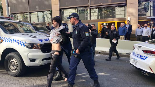 Mert Ney is detained by police in Sydney, yesterday. Picture: AAP