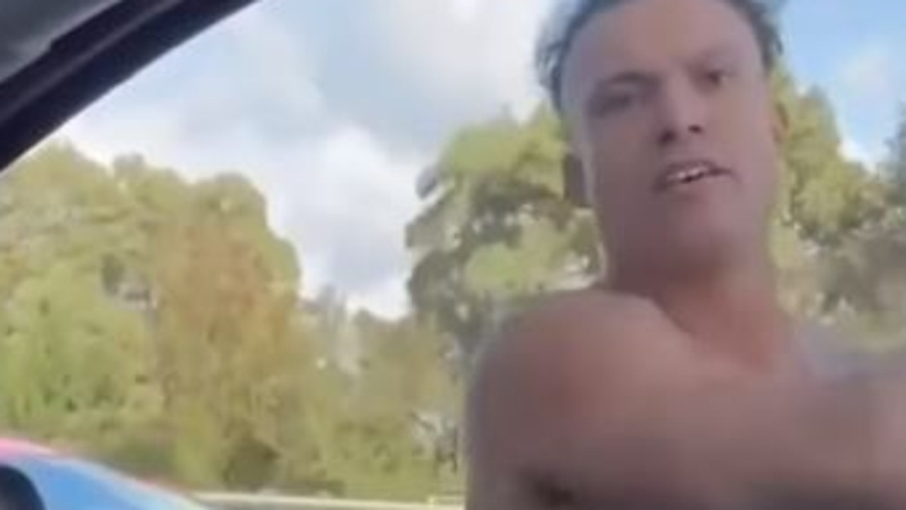 Bizarre footage has emerged of a shirtless man smashing a car window and yelling about vaccines. Picture: 9NEWS