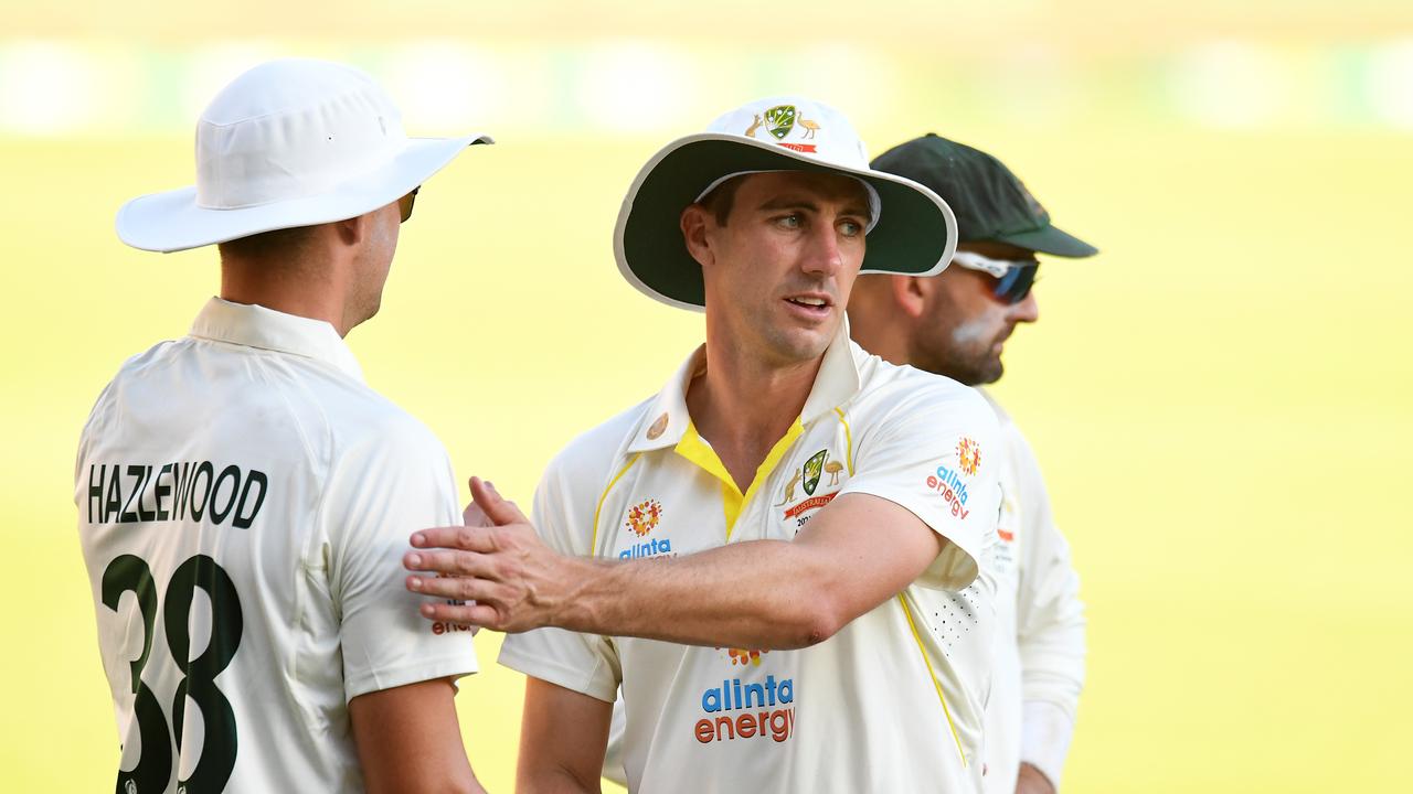 BRISBANE, AUSTRALIA - DECEMBER 10: Australia captain Pat Cummins pats team mate Josh Hazlewood at the end of play during day three of the First Test Match in the Ashes series between Australia and England at The Gabba on December 10, 2021 in Brisbane, Australia. (Photo by Albert Perez - CA/Cricket Australia via Getty Images)