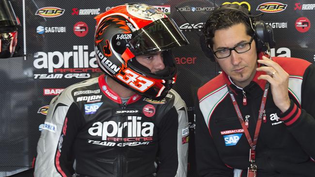 Marco Melandri speaks with an Aprilia mechanic at Assen.