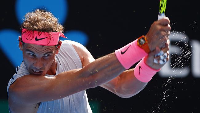 Sweat flies as Rafael Nadal rips a backhand during the 2018 Australian Open. Picture: Michael Klein