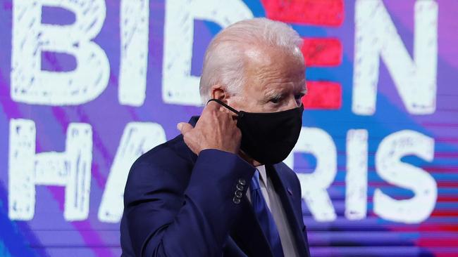 Democratic presidential nominee Joe Biden takes off his mask as he arrives at a campaign event to speak on the coronavirus pandemic in Wilmington, Delaware.