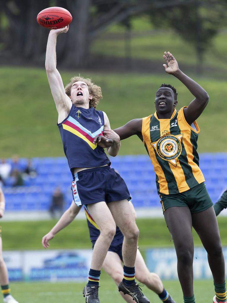 Guilford Young College’s Ryan Hapka holds off St Patrick’s College’s Tony Aganas. Picture: Chris Kidd