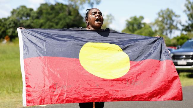 A relative yells messages of support after the meeting at the Mareeba Community Church Fellowship centre into the shooting death of Aubrey Donahue. Picture: Brendan Radke