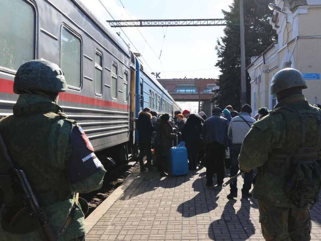 Military police officers guard a railway station while citizens of the Donetsk People's Republic (DPR) are being evacuated.