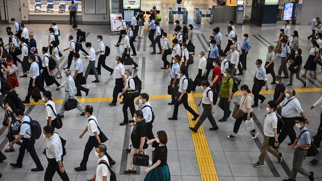 People commute early morning in Tokyo on August 17. Picture: Charly Triballeau/ AFP.