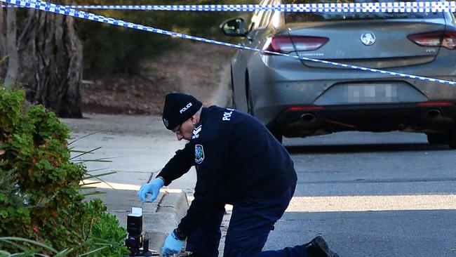 Police investigators gather evidence at the scene. Picture: AAP/Mark Brake