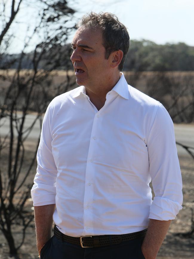 South Australian Premier Steven Marshall walking devastated properties along Playford Highway on Kangaroo Island. Picture: AAP/Emma Brasier