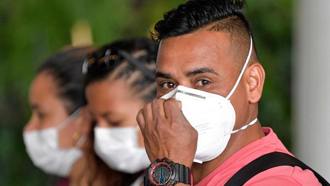 People wear protective face masks as a preventive measure against the spread of the new coronavirus, COVID-19. Photo: Raul ARBOLEDA / AFP