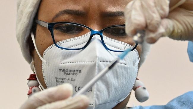 A health worker prepares a dose of the Covid vaccine. Picture: Justin Tallis/AFP