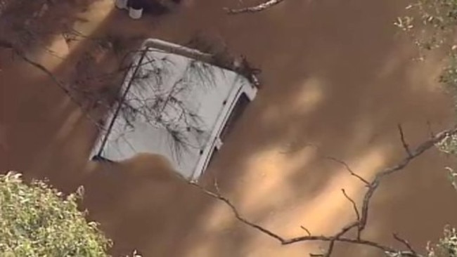 Police divers are at the scene of a submerged ute in floodwater at Leppington. Source: Twitter @9NewsSyd