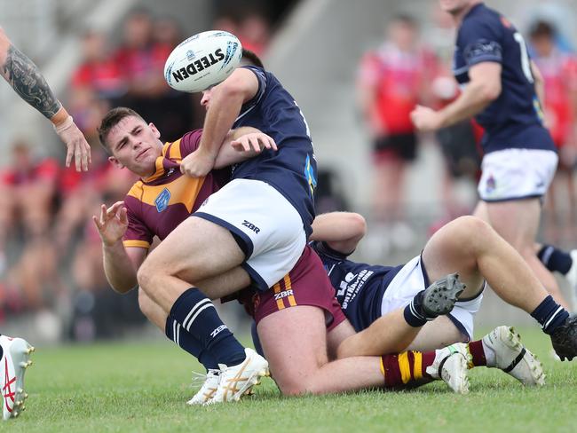 Riverina’s Royce Tout is tackled. Picture: Sue Graham