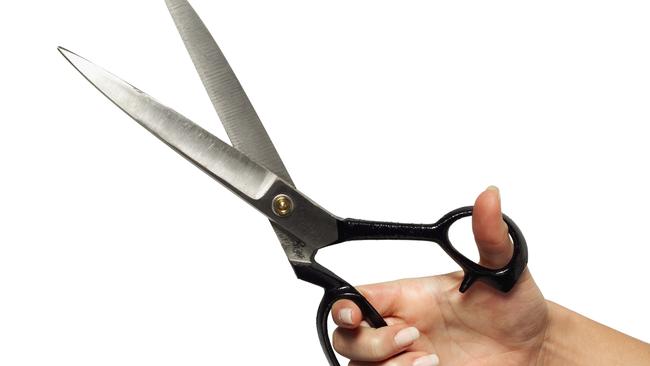 Close-up of woman's hand holding scissors. Cutting. Cuts. Generic image.