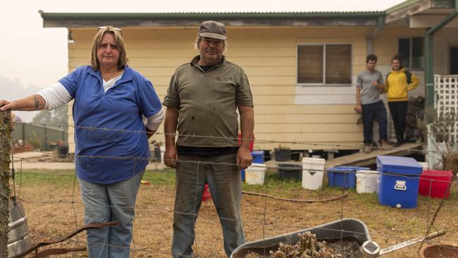 Stephen and Janet Lennon at their home in Nambugga NSW with family friends Brittany Reukers (19) (from the Netherlands) and Jordan Coffey (20) from Canberra, who came down to help them prepare. Picture: Sean Davey.