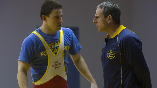 Influence ... Mark Schultz (Channing Tatum) listens intently to the nonsensical instruction of would-be wrestling coach John du Pont (Steve Carell).