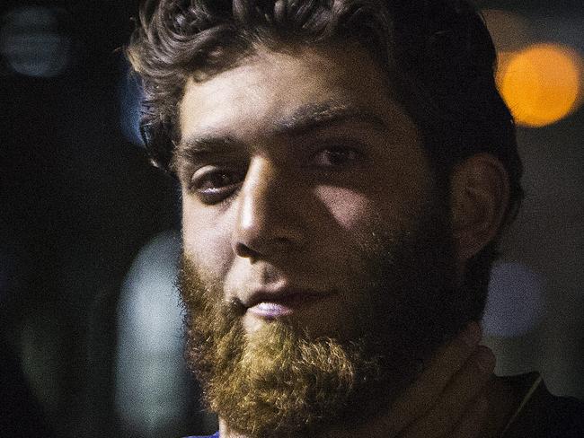 A man strokes his beard while Muslims gathered in at Lakemba Rail Station to rally after a series of police raids against a terror plot. Photos: Chris McKeen