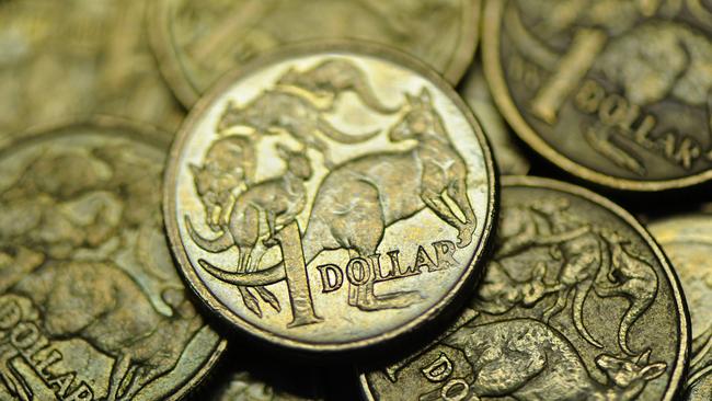 Close-up of used Australian one dollar coin photographerd in Melbourne, Wednesday, June 13, 2012. Reserve Bank of Australia governor Glenn Stevens today said there are big benefits to Australian's as consumers from the high Aiustralian dollar (AUD). (AAP Image/Julian Smith) NO ARCHIVING