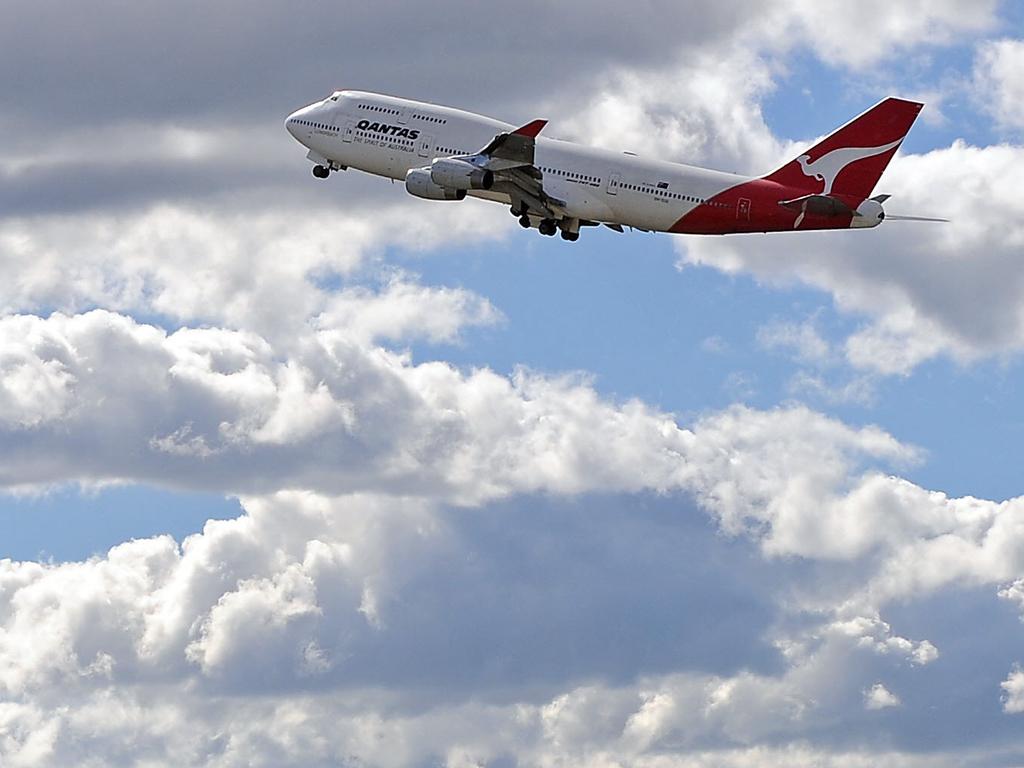 A Qantas Boeing 747-400 takes off from Sydney International Airport.