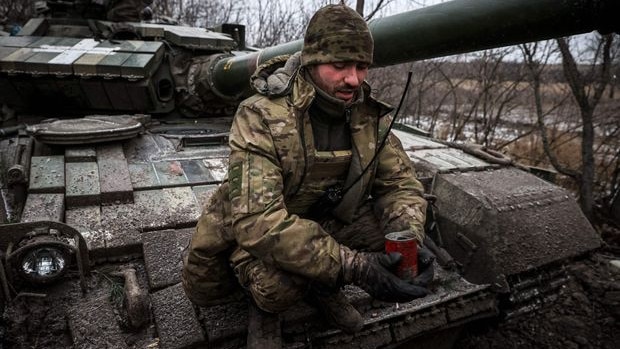 A Ukrainian serviceman holds a can used as a makeshift heater — also known as a ‘trench candle’. Picture: Getty Images