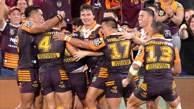 Anthony Milford is mobbed by Broncos teammates after his golden point heroics.