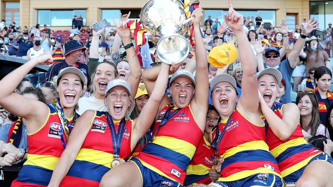 Crows players Caitlin Gould, Marijana Rajcic, Ebony Marinoff, Chelsea Biddell and Ashleigh Woodland celebrate.