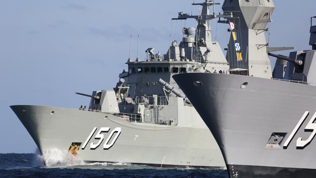 Anzac-class frigate HMAS Anzac (150) passes HMAS Ballarat (153) during a transit through Cockburn Sound in Western Australia on the way to Fleet Base West. *** Local Caption *** The Anzac Class is based on the German Meko 200 frigate design with eight ships being constructed in Australia as part of the overall plan to upgrade the Royal Australian Navy. Anzacs are long-range escorts with roles including air defence, anti submarine warfare, surveillance, reconnaissance and interdiction. The ships are capable of countering simultaneous threats from the air, surface and sub-surface. Powered by a combined diesel or gas (CODOG) propulsion plant permits speeds in excess of 27 knots with an operational range of more than 6000 nautical miles.