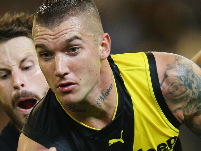 MELBOURNE, AUSTRALIA - MARCH 23:  Dustin Martin of the Tigers is tackled by Matthew Wright of the Blues during the round one AFL match between the Carlton Blues and the Richmond Tigers at Melbourne Cricket Ground on March 23, 2017 in Melbourne, Australia.  (Photo by Michael Dodge/Getty Images)