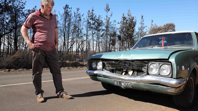 Gosse local Jonny Gloyne with his banged up Holden Kingswood. Picture: Dean Martin