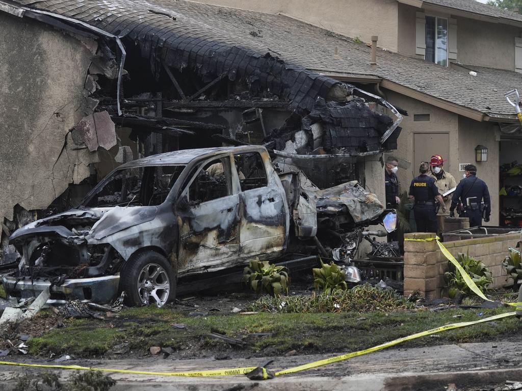 Authorities work the scene where a small plane crashed into a San Diego neighborhood, setting several homes on fire and forcing evacuations along several blocks early Thursday, May 22, 2025. Picture: AP Photo/Gregory Bull.