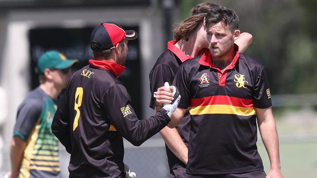 St Joseph's Jonathan Casey congratulates bowler Scott Condy on taking down Darcy Pearson with a clean bowl. GCA1: South Barwon v St Joseph's at South Barwon. Picture: Alan Barber