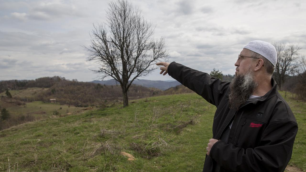 EMBARGO APPLIES - DO NOT PUBLISH BEFORE 14 MAY 2016 .. OSVE, BOSNIA. March 2016 - Buried deep in the north Bosnian woods 130km north of Sarajevo is the village of Osve, a community of Salafist Islamists who dismiss claims they are running a terrorist camp amid their fields of fruit and vegetables but admit many of its members have left to fight with the group in Syria. Former rock band guitarist turned Salafist community leader Izet Hadzic shows us the lans bought by Harun Mehicevic. Izet denies he supports ISIS and says instead he is working with intelligence services to expose sympathisers. Picture Ella Pellegrini