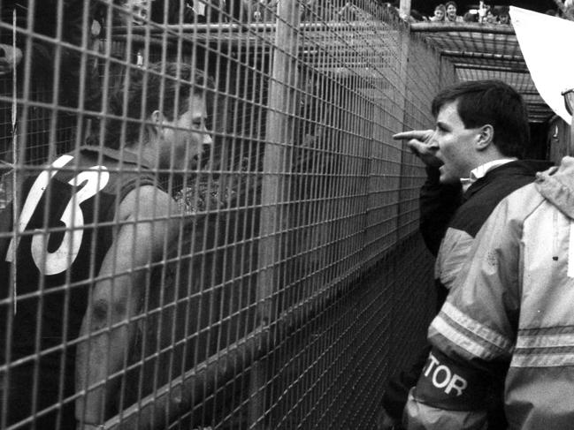 Injured Eagle John Worsfold clashes with Jakovich over the fence in the players race in 1991. Picture: Supplied