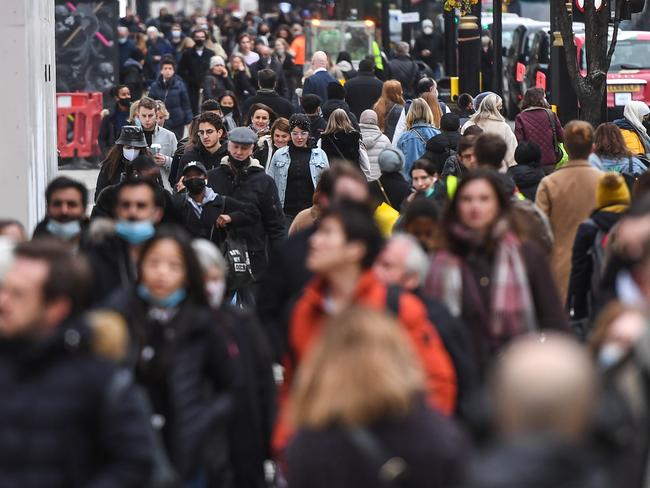 LONDON, ENGLAND  - DECEMBER 02: Crowds of shoppers are seen on Oxford Street on December 2, 2020 in London, England. Last night MPs voted in favour of government proposals to enter England into a tiered system of lockdown beginning at midnight. Residents of Tier Two - High Alert can socialise with anyone they live with or who is in their support bubble in any indoor setting, whether at home or in a public place. Outdoors they must observe the rule of six. Pubs and bars must close, unless operating as restaurants. Hospitality venues can only serve alcohol with substantial meals and must close between 11pm and 5am with last orders called at 10pm. Organised indoor sport, physical activity and exercise classes will be permitted if it is possible for people to avoid mixing with people they do not live with. Schools remain open. (Photo by Peter Summers/Getty Images)