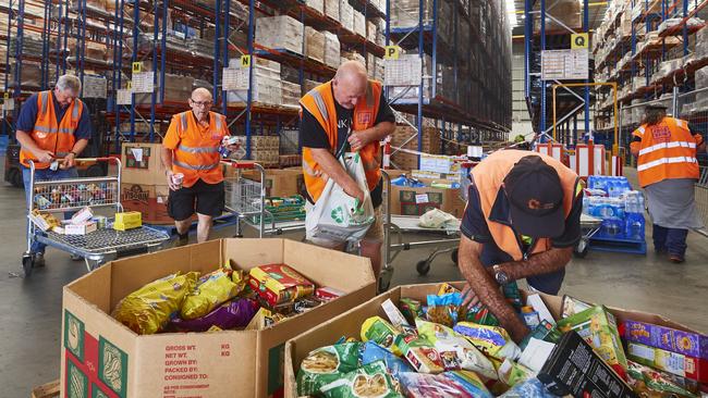 Volunteers help help organise large donations of goods at the Food Bank Distribution Centre bound for areas impacted by bushfires. Picture: Getty Images