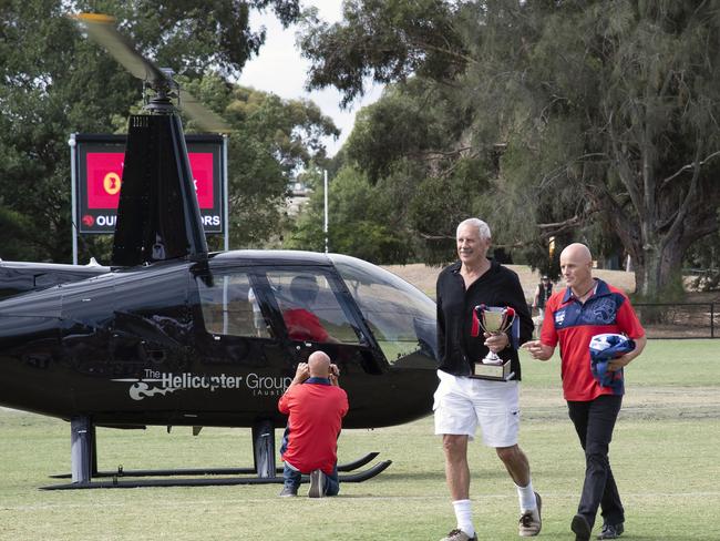 Highett’s 2018 premiership Cup arrives by helicopter with Darrell “Goose’’ Mackenzie and Andrew Robinson.