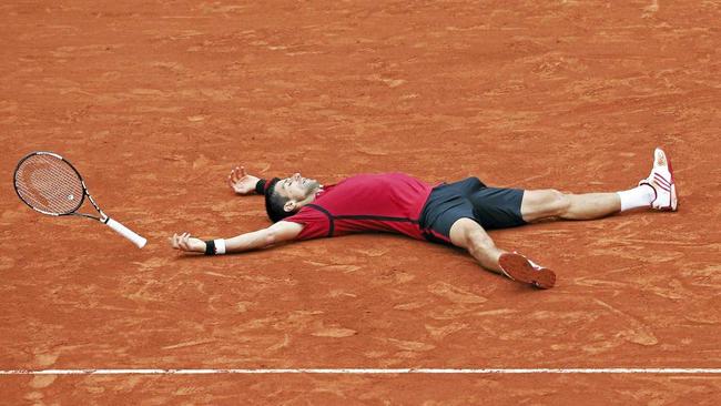 CLAY FEAT: A relieved Novak Djokovic tries to take in his win in the French Open. Picture: Christophe Ena