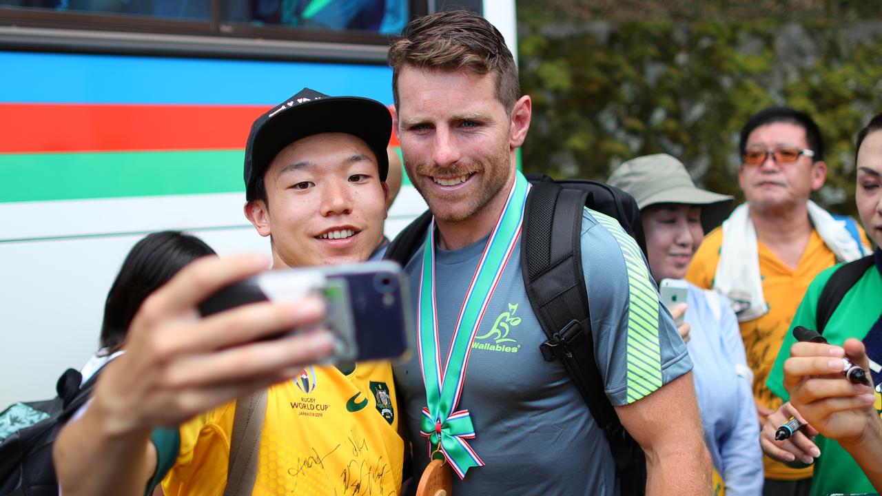 Bernard Foley of Australia poses for a picture with locals at Odawara Stadium.