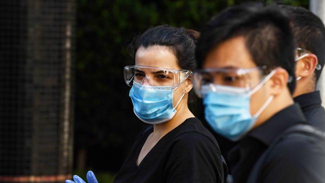 Medical staff and police prepare for a coronavirus testing blitz inside Peppers Hotel. Picture: Brenton Edwards