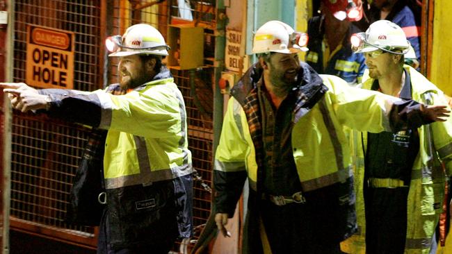 Tasmanian miners Todd Russell and Brant Webb wave as they emerge from the mine lift having been rescued after being trapped underground at Beaconsfield gold mine for 14 days. Picture: Ian Waldie/Getty Images