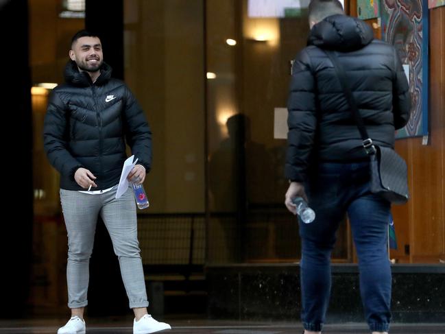 George Mandilis celebrates outside court with a picture. Picture: NCA NewsWire/Damian Shaw