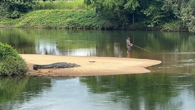 A British expat caught this hair-raising image of an Aussie fisherman fishing just metres from a saltwater croc. Picture: Supplied.