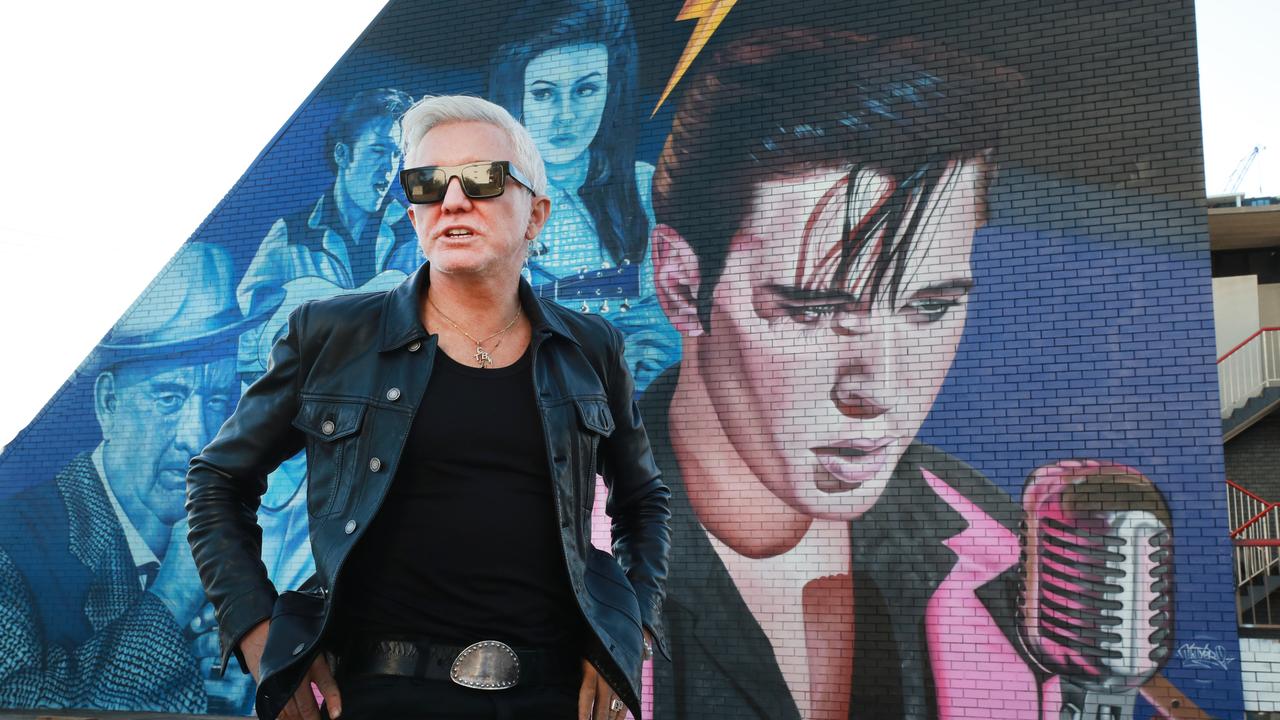 Film director Baz Luhrmannin front of the giant Elvis Presley mural at Burleigh Heads. Picture: Scott Powick